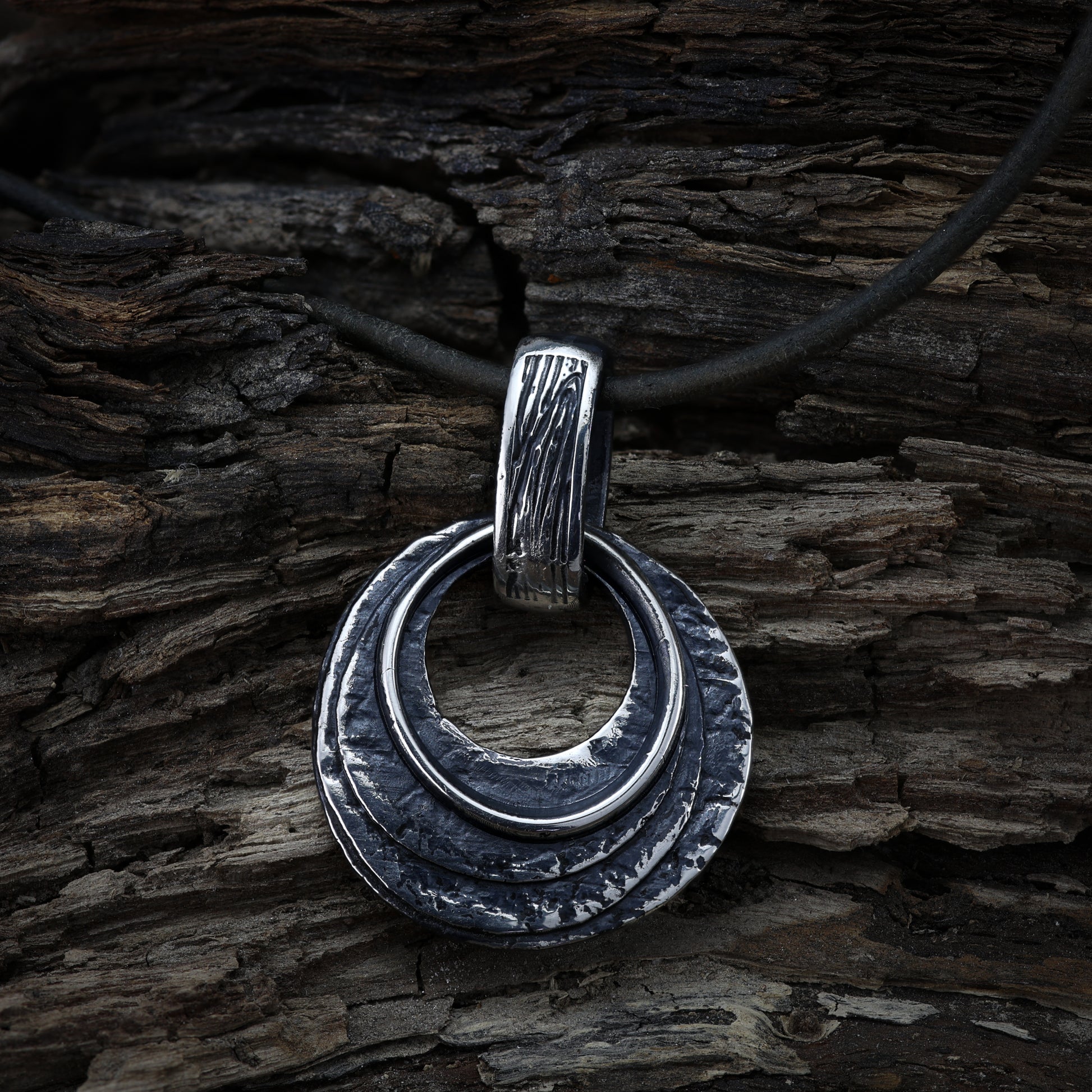 Textured silver pendant reflecting Viking art, a statement piece for Pagans.