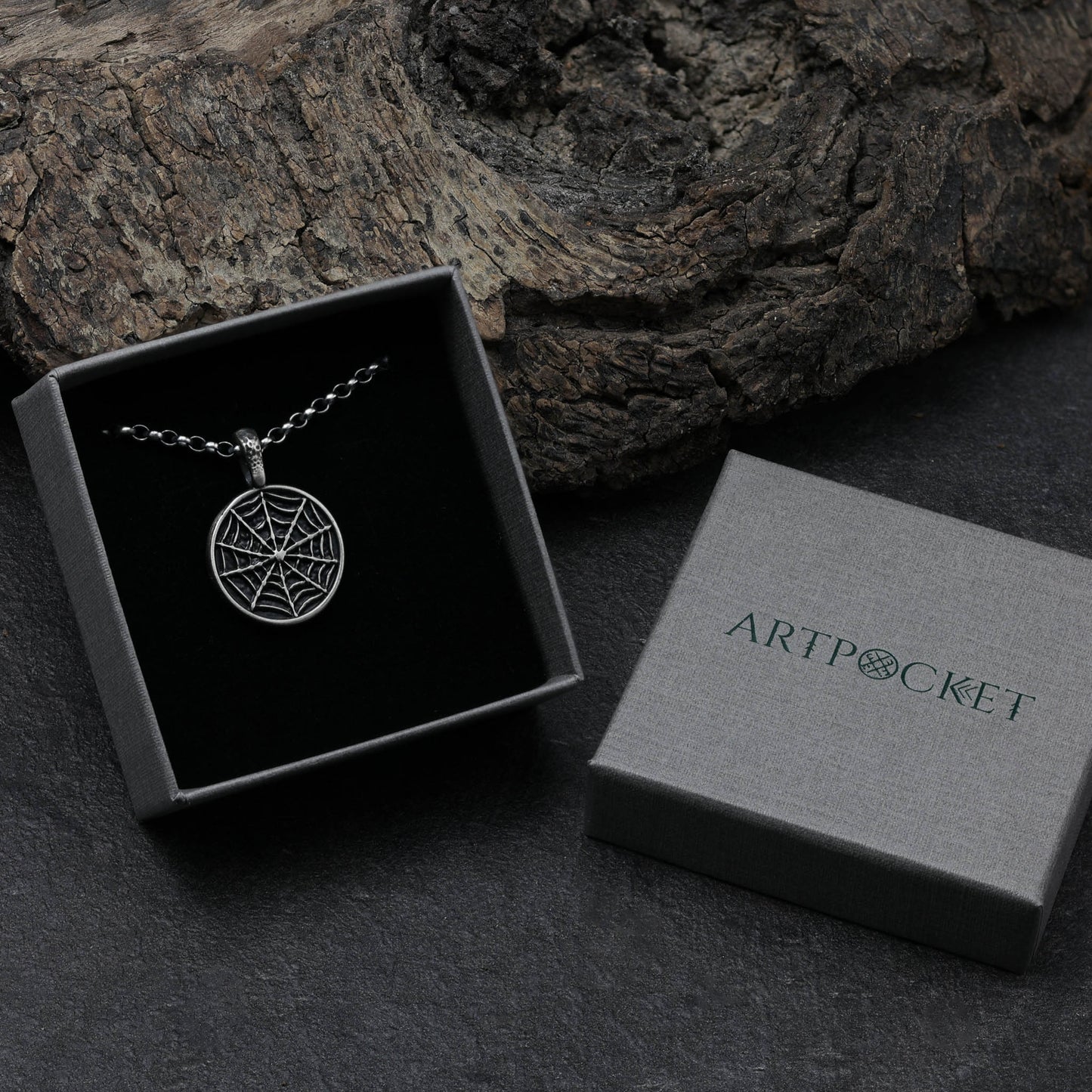 Elegant sterling silver spider web pendant with fine details.