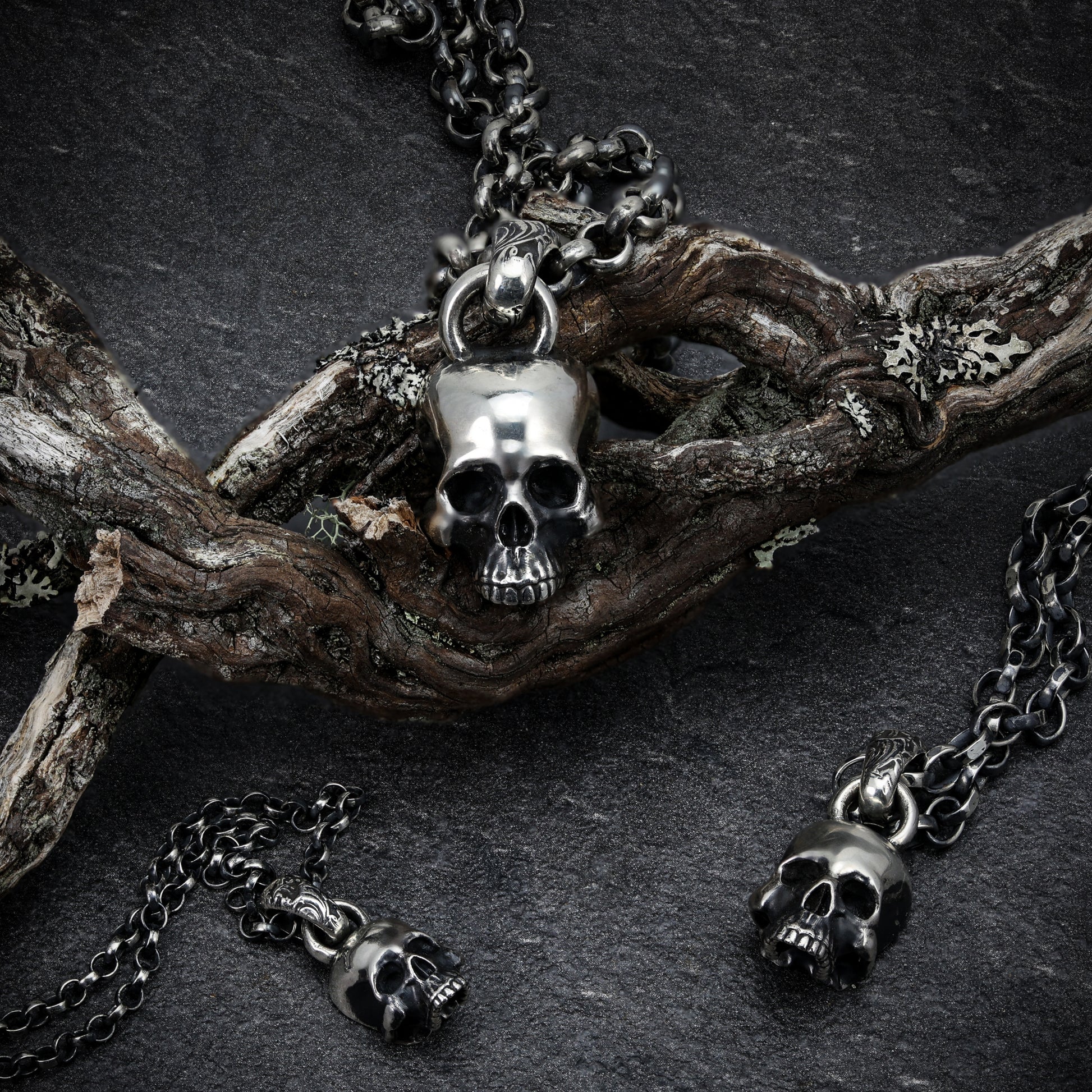 Sterling Silver Skull Pendant hanging against a dark background.