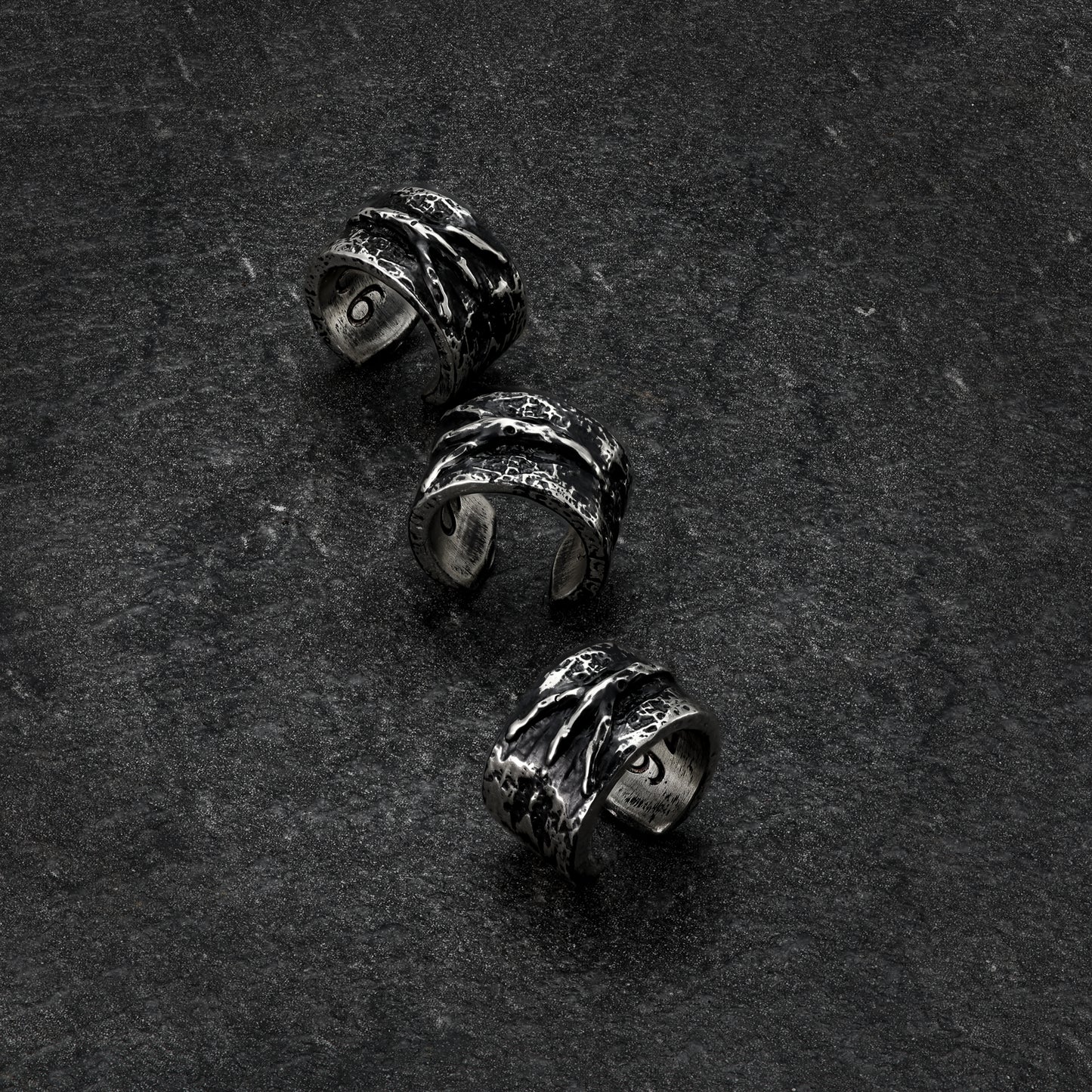  A single image showcasing the same design of the ear cuff from multiple angles, providing a comprehensive view of its shape and details of the Rune ear cuff.