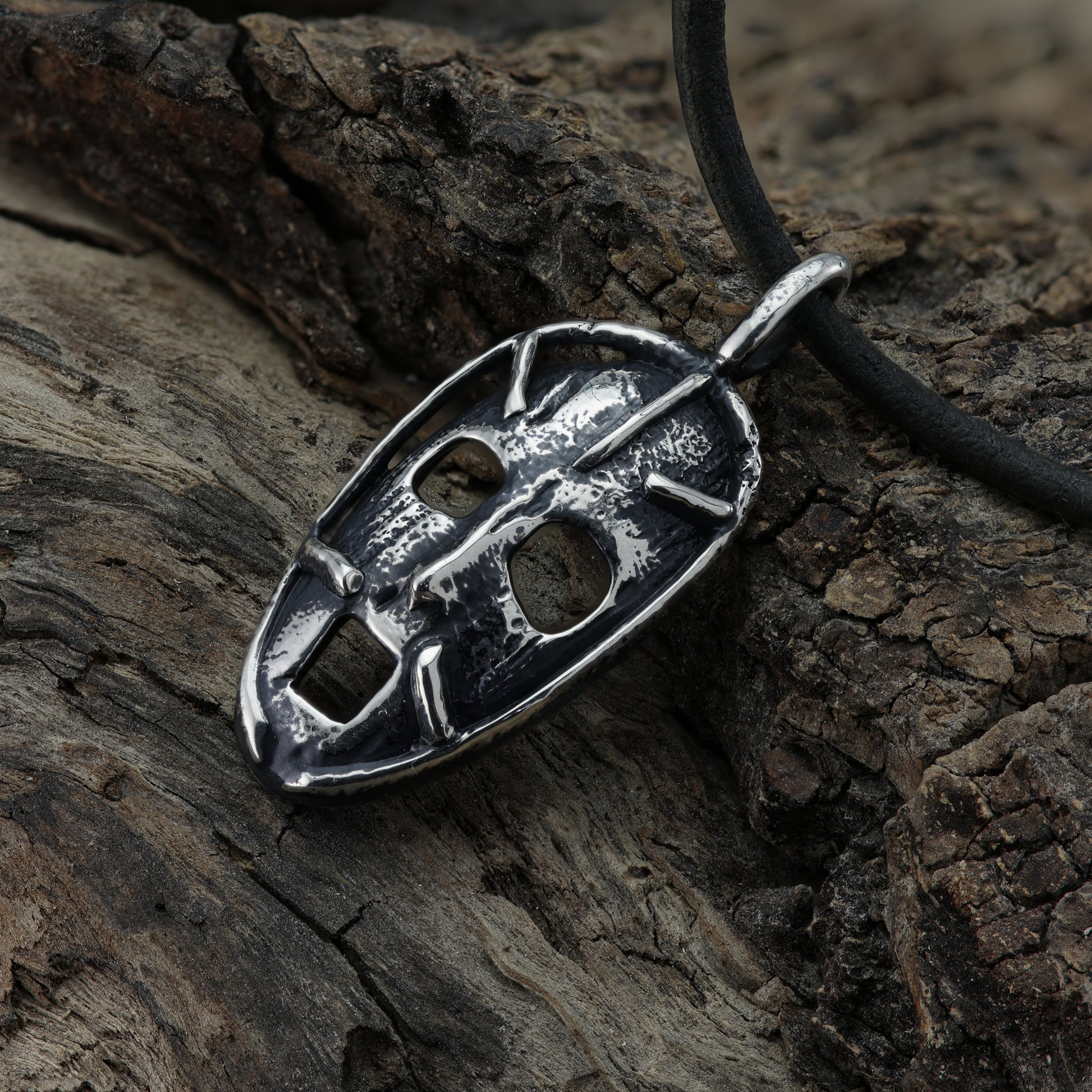 Close-up image of the 'Prison of the Mind' pendant, showcasing the intricate broken wire design