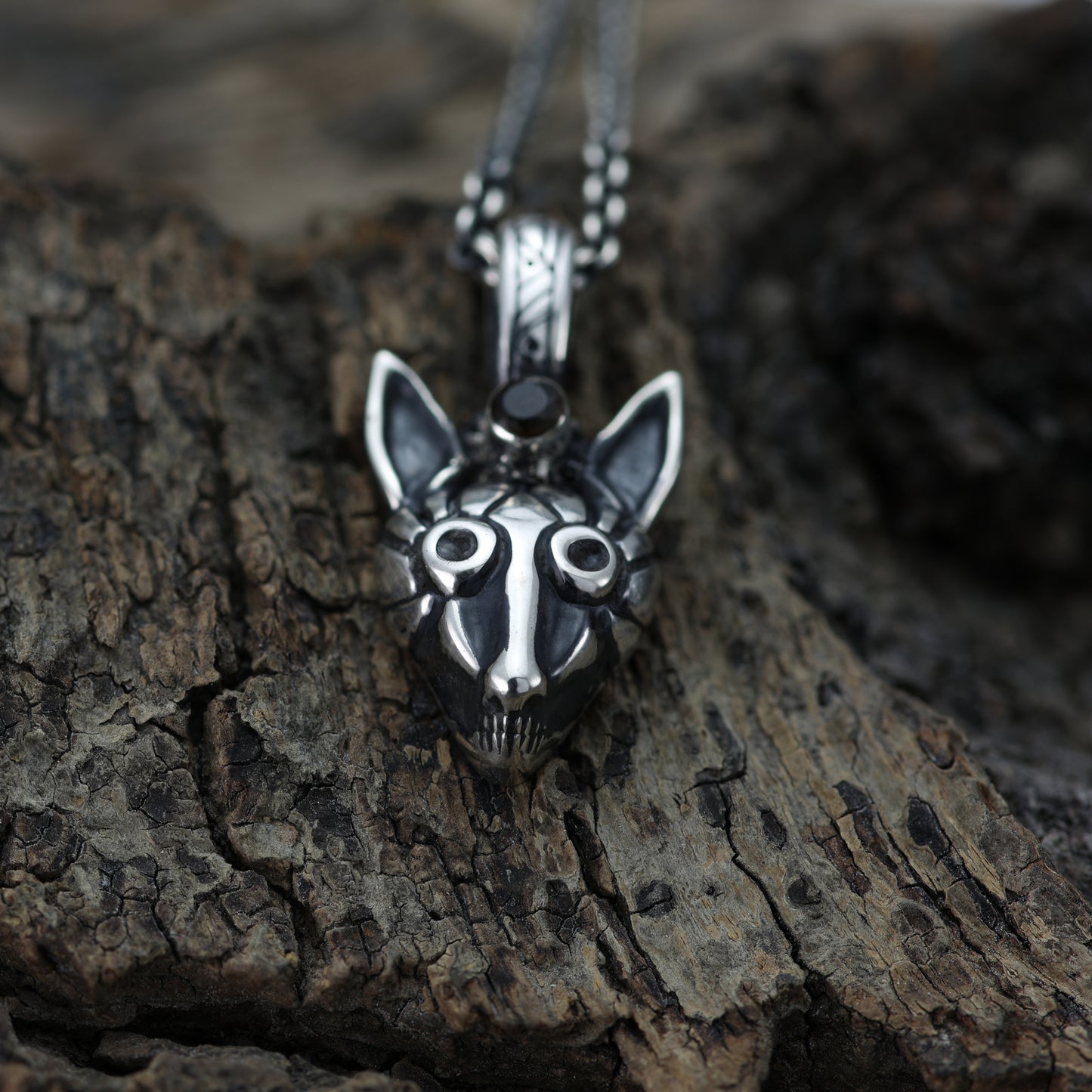 ngled view of fox pendant showcasing intricate tribal carvings.