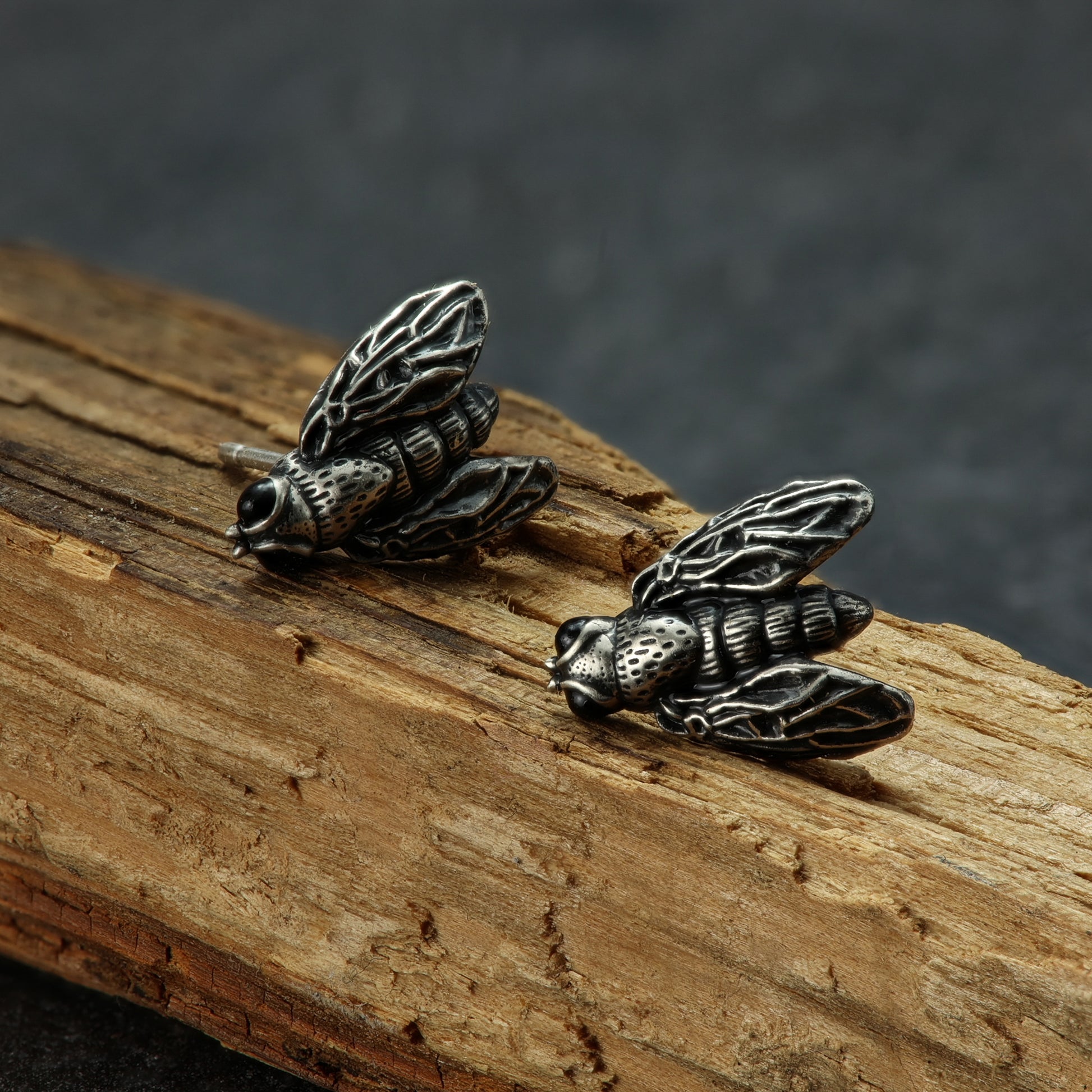 Quirky sterling silver earrings with an enamel fly design.