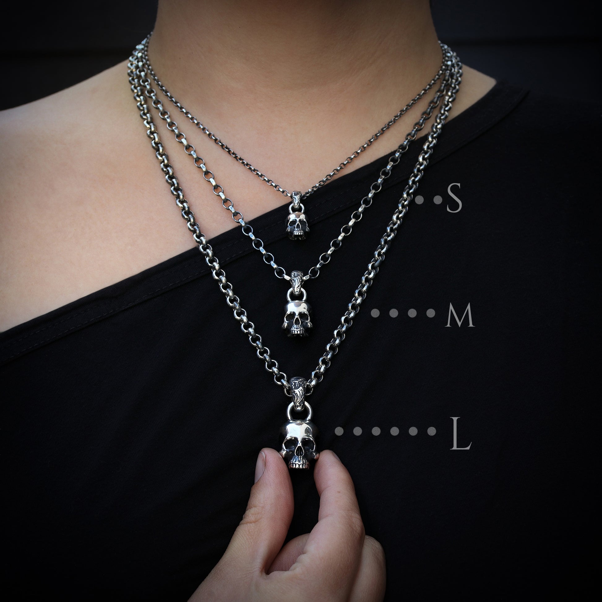 Dimensions measurements for S, M, L size Sterling Silver Skull Pendants on the model.