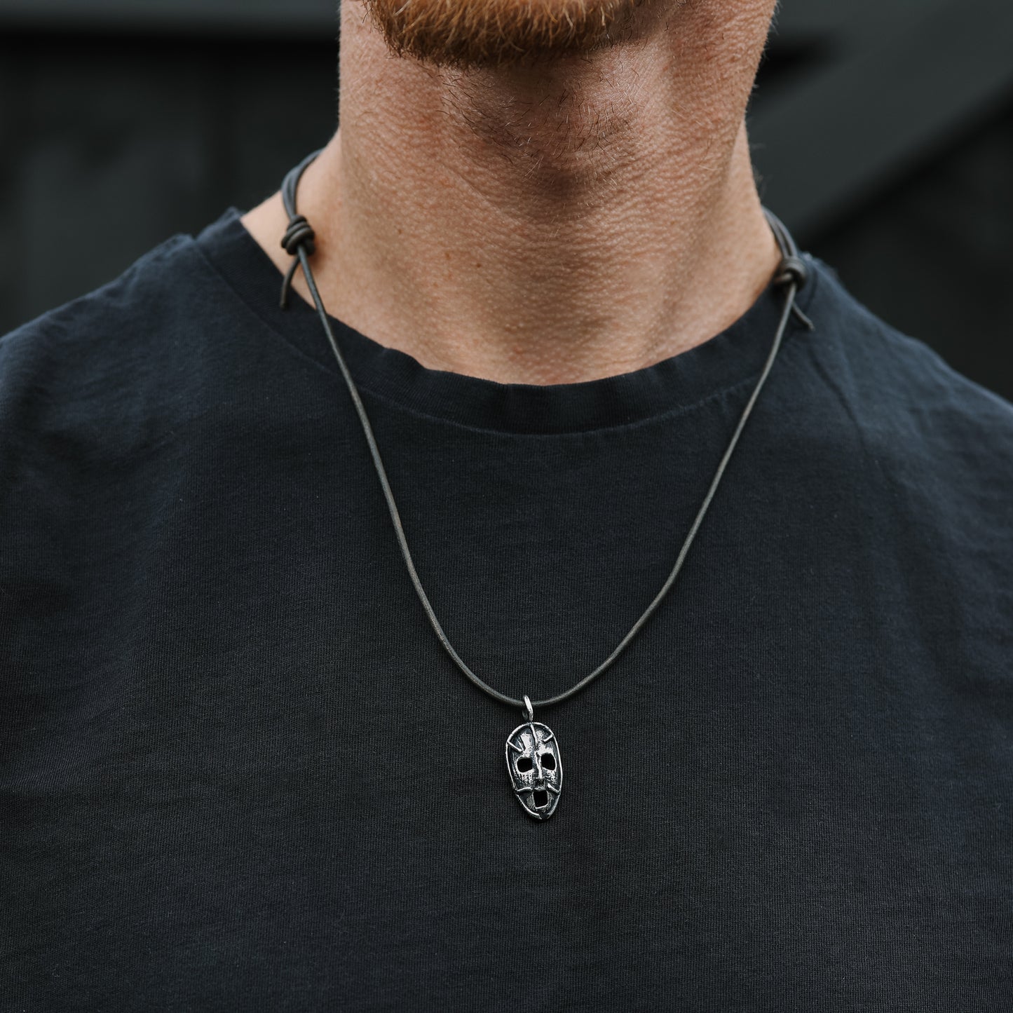 A model wearing the 'Prison of the Mind' pendant with a black outfit, highlighting how the pendant looks when worn