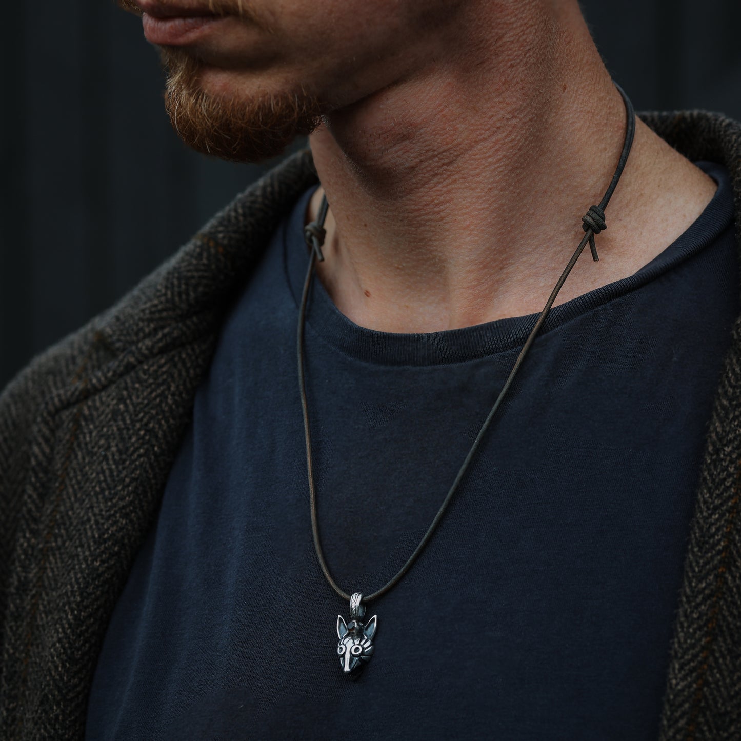 Model wearing the fox pendant, showcasing how it sits against the skin.