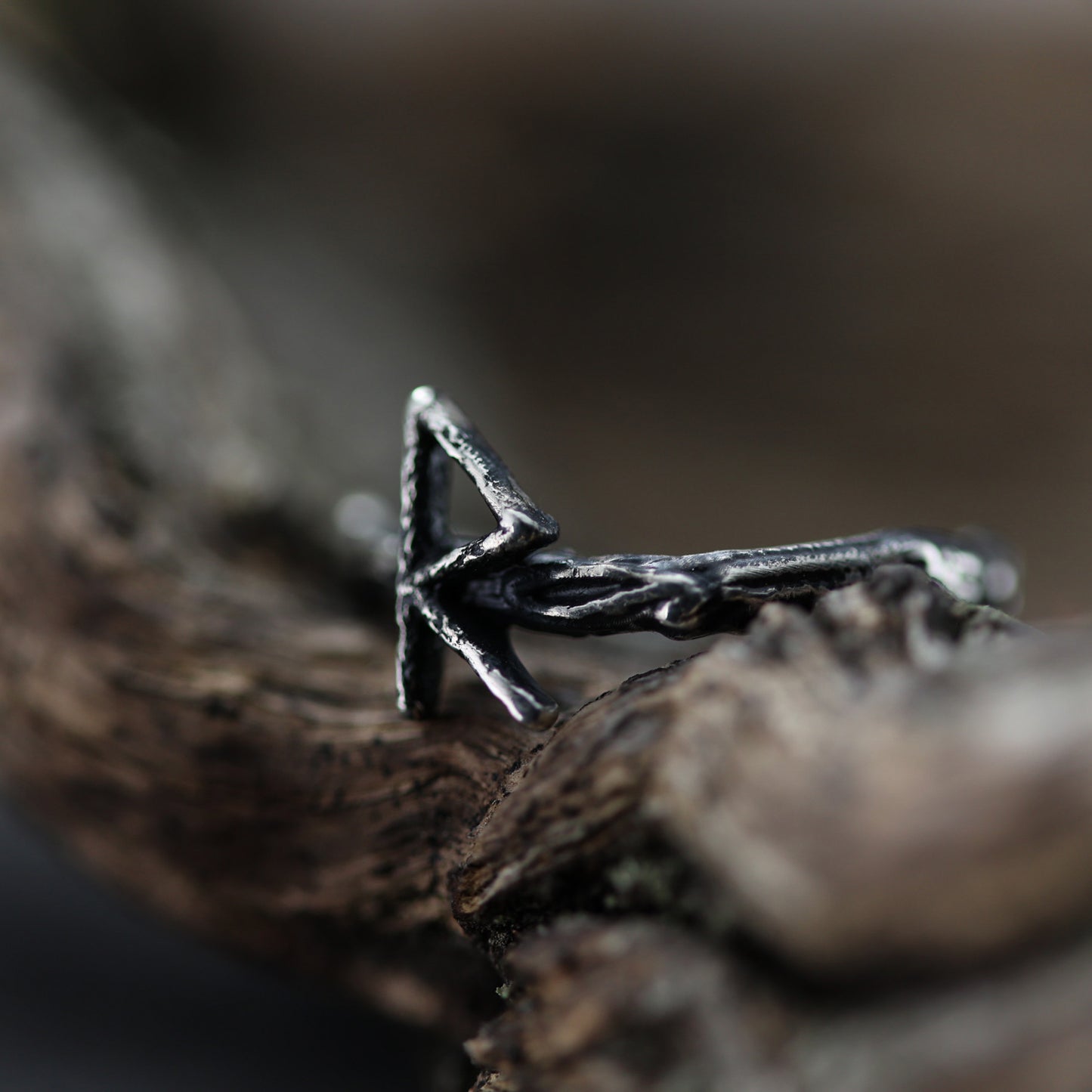 Handcrafted sterling silver ring adorned with ancient runic symbols