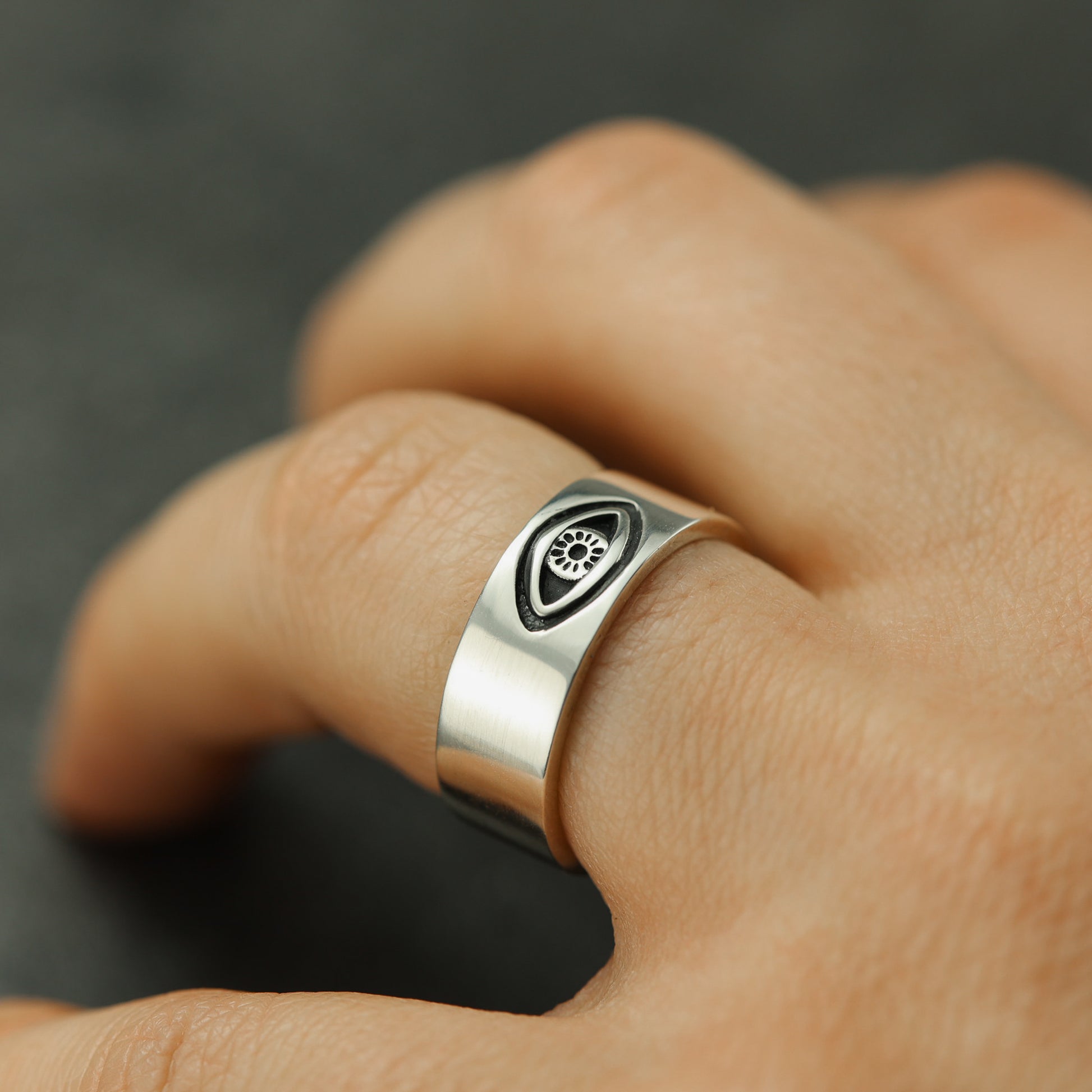 Evil eye, all-seeing eye ring on finger. Sterling silver.