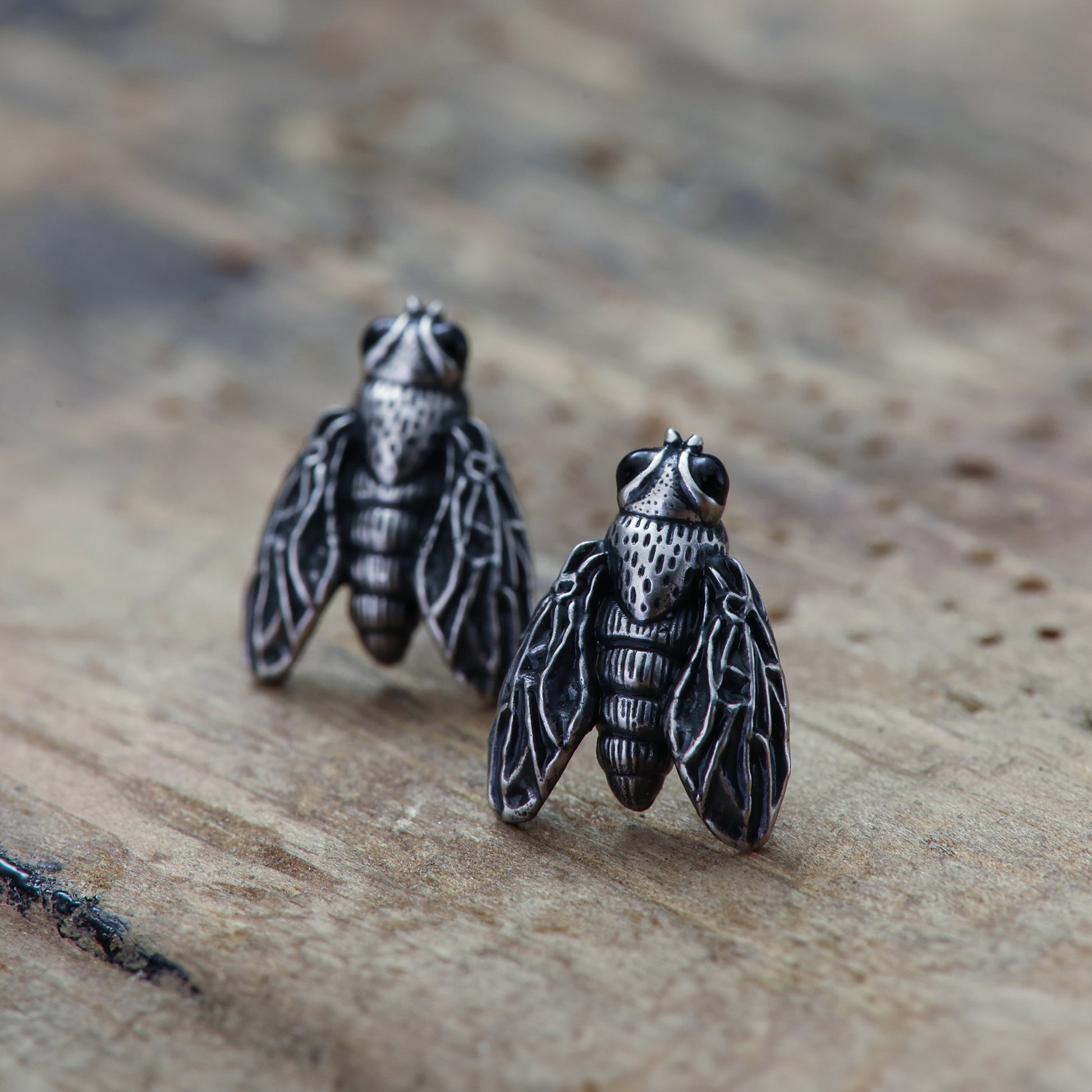 Sterling silver earrings styled as whimsical flies.