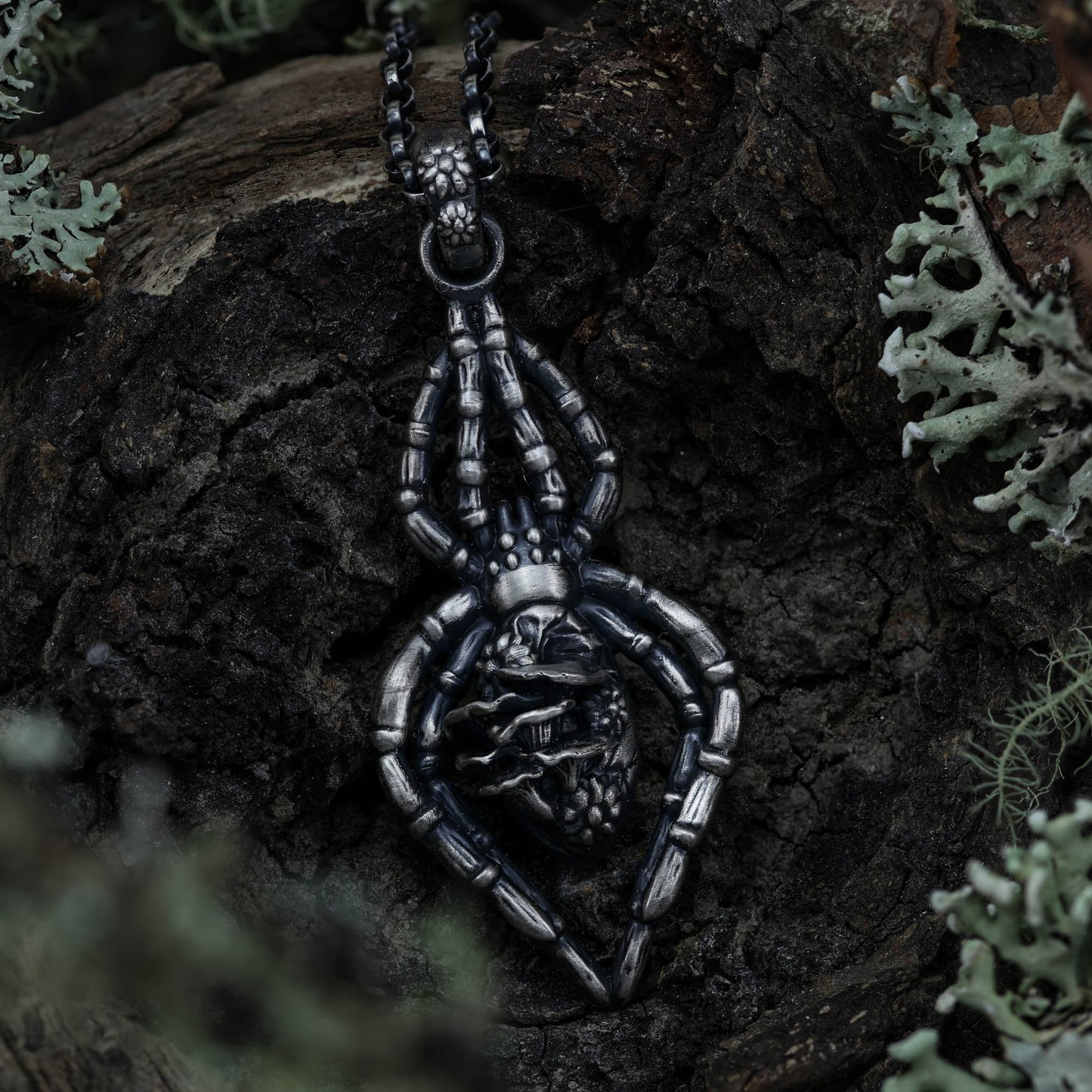 A stunning spider necklace with a highly detailed sterling silver spider, adorned with tiny flowers and mushrooms for a touch of magic and fantasy..