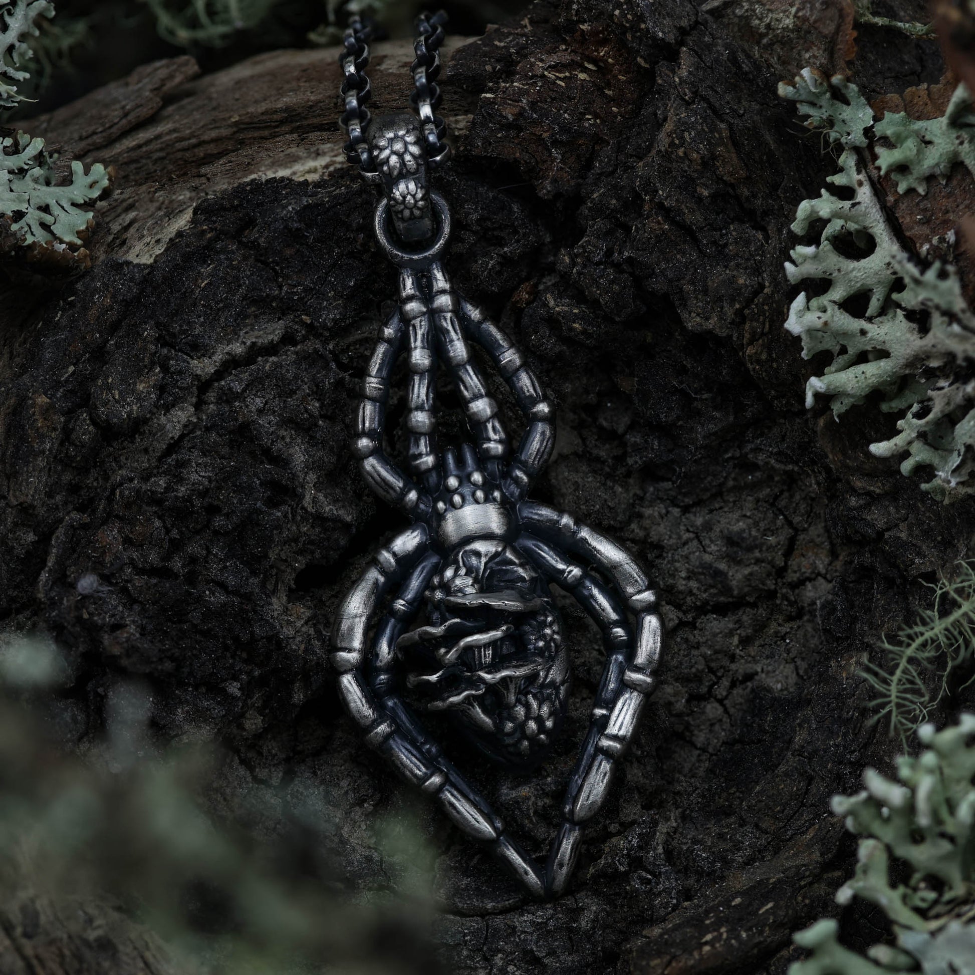 A stunning spider necklace with a highly detailed sterling silver spider, adorned with tiny flowers and mushrooms for a touch of magic and fantasy..