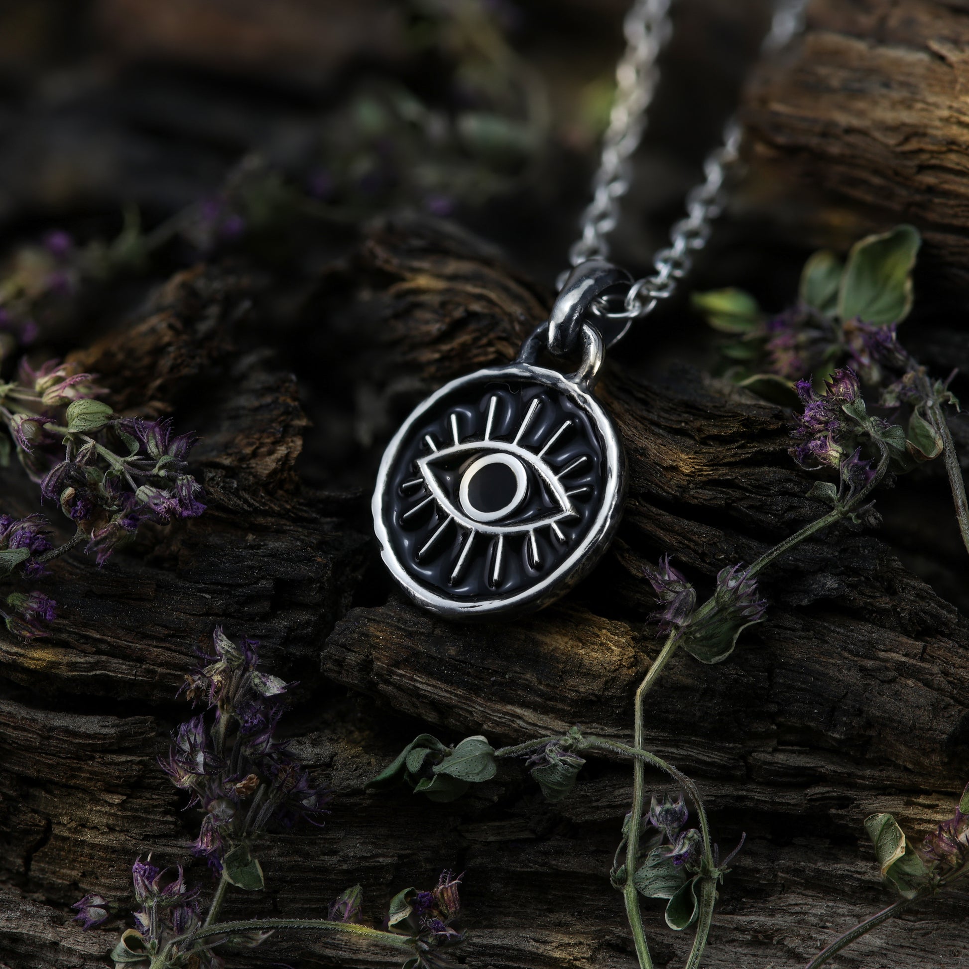 The third eye pendant necklace against a dark background, emphasizing its mystical and enchanting nature.