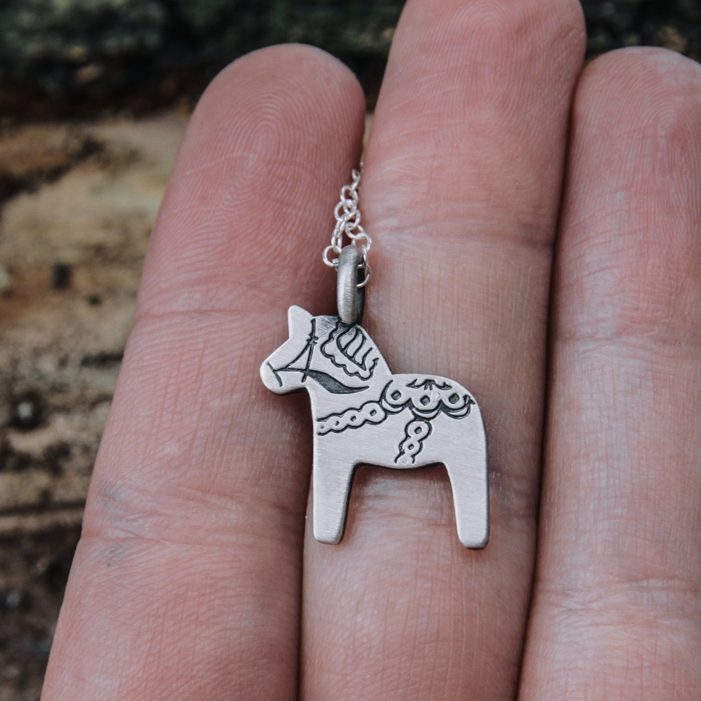 Dala horse necklace.